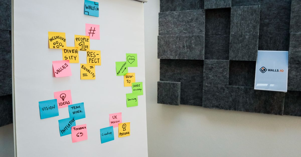 Feedback sticky notes on printed webpage screenshots.