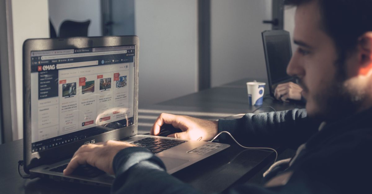 Website speed basics for a small business site: an owner running a free speed test on a laptop.